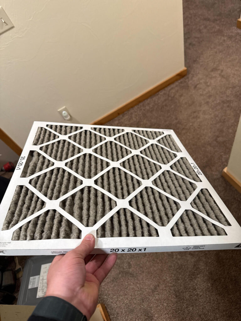 Ac Filters - hand holding a dirty filter